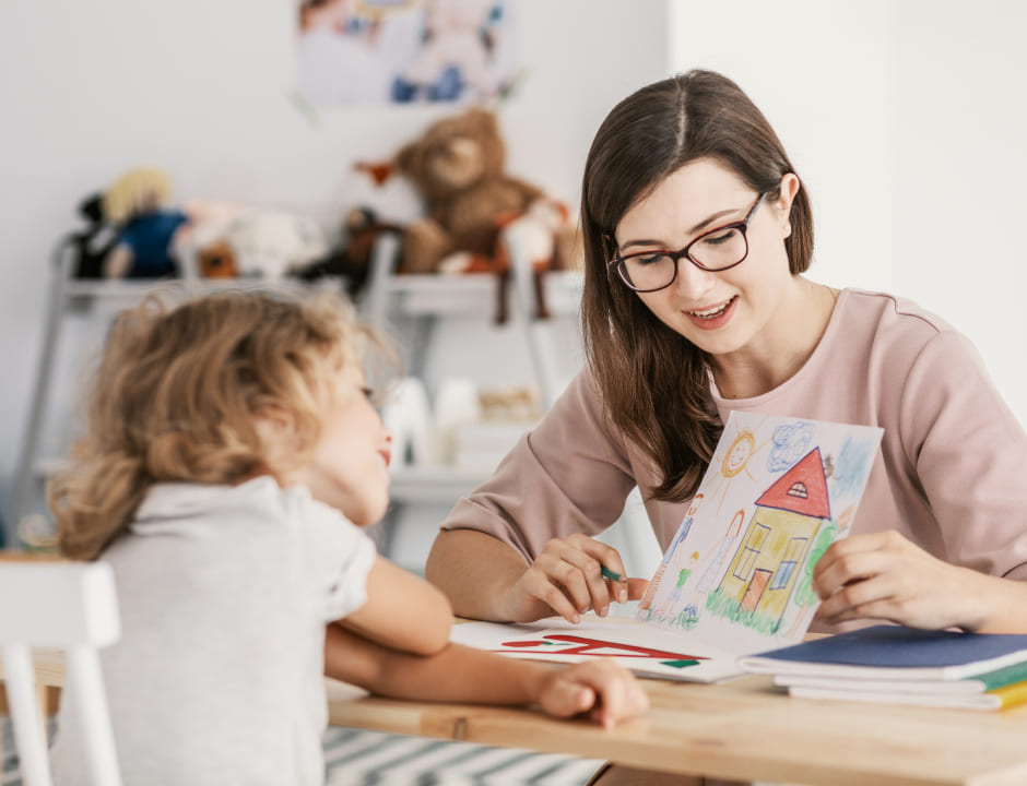 woman showing a drawing to a girl