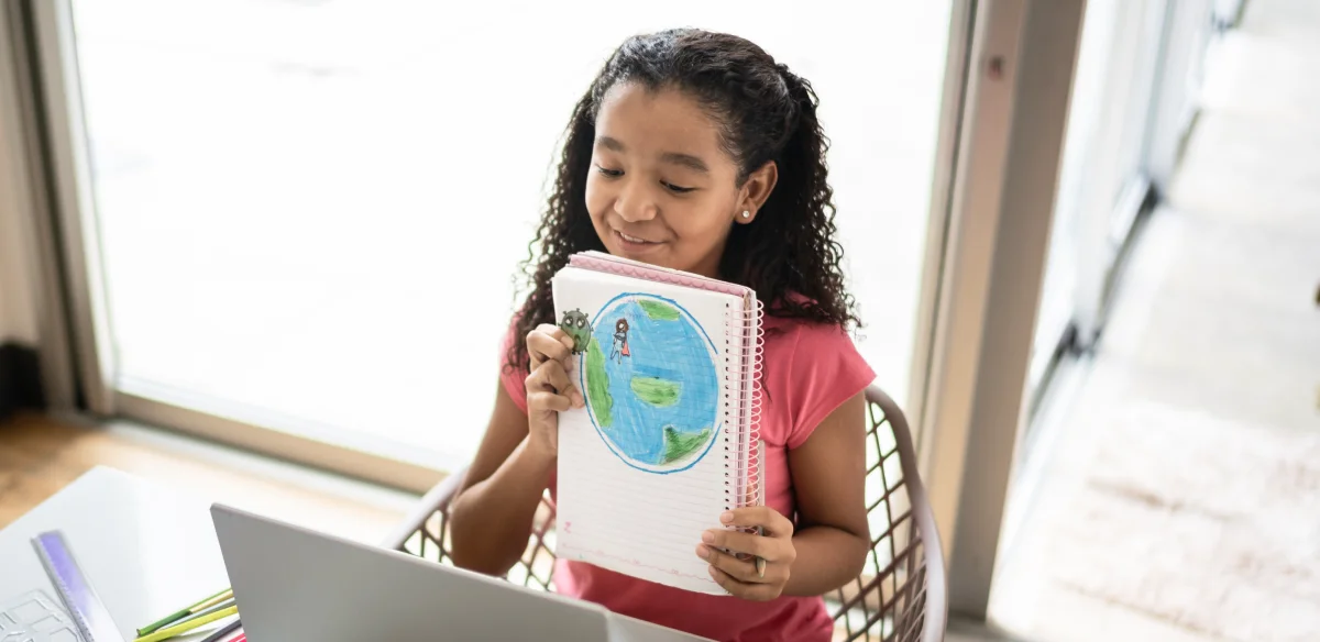 Elementary school student showing a draw to her online class